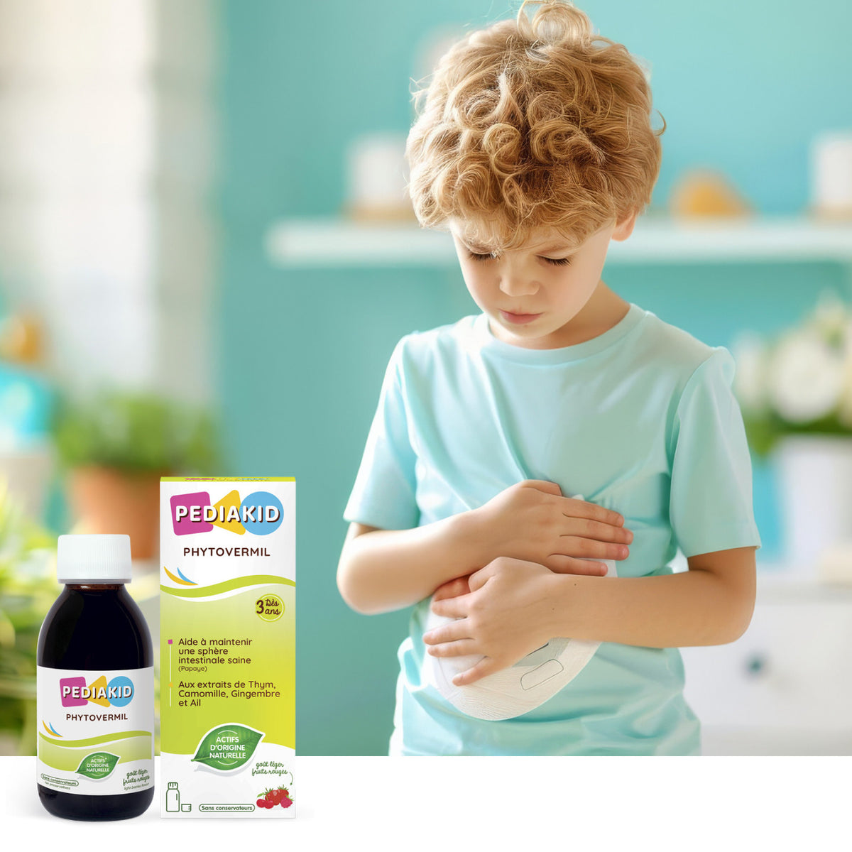 PEDIAKID Phytovermil sirop 125 ml - băiețel cu mâna pe burtică, alături de flaconul și cutia produsului